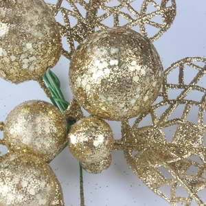 Macro shot of gold glitter berries and hollow mesh leaves for Christmas DIY decor