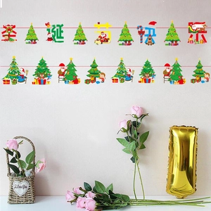 Close-up of paper Christmas banners with Merry Christmas text and cartoon Santa Claus