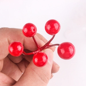 Artificial red Christmas berries with five heads on a branch for holiday wreaths