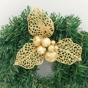 Close-up of champagne gold glitter hollow leaves and berries for Christmas wreaths