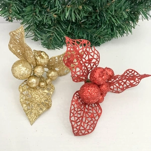 Detail of red and gold glitter hollow leaves with berries for Christmas DIY decor