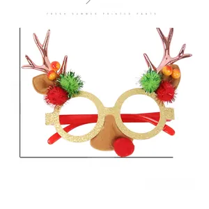 Detailed view of Christmas reindeer glasses frame with festive pom-poms and antlers