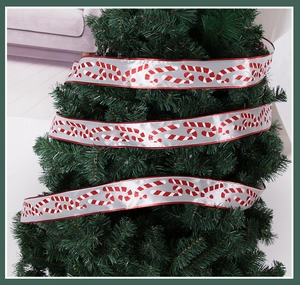 Silver satin Christmas ribbon with red glitter candy canes wrapped on a festive tree
