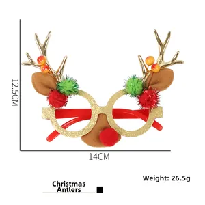 Close-up of golden glitter Christmas glasses with reindeer antlers and red pom-poms
