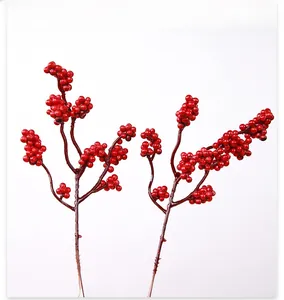 Close-up of artificial red berry branches with glossy finish for festive home decor