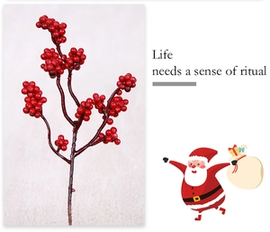Close-up of artificial red berries on branches for Christmas festive home decoration