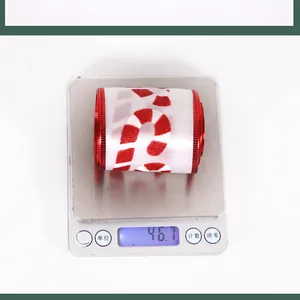 Detail showing red candy cane ribbon on scale weighing approximately 46.7 grams