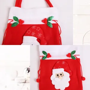 Detail of red and white Christmas gift bag featuring a 3D Santa Claus applique and drawstrings