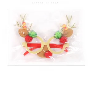 Detailed view of Christmas glasses with reindeer antlers and colorful pom poms