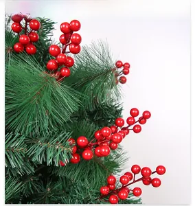 Close-up of artificial red berries and green pine needles for Christmas decoration