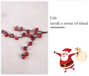 Close-up of frosted red berries branches with snow effect for Christmas tree decoration