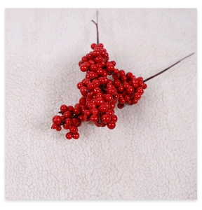 Close-up of vibrant red artificial berry branches for festive DIY Christmas home decoration