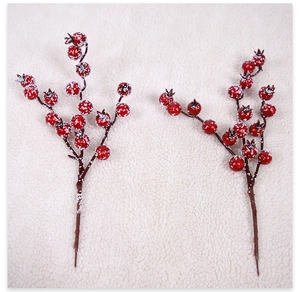 Detail of faux red winter berries with frosted snow effect for Christmas tree decoration