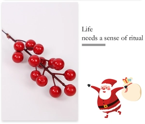 Close-up of artificial red berries on brown stems for Christmas decor with festive text