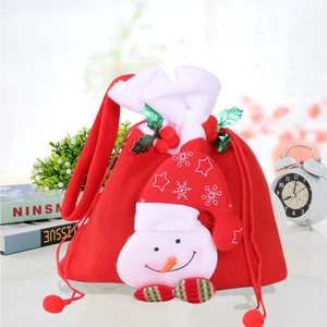 Detail of red Christmas snowman gift bag with drawstring and festive holiday decorations