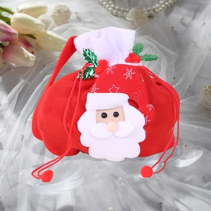 Detail of red velvet Christmas gift bag with Santa Claus applique and plush pom-poms