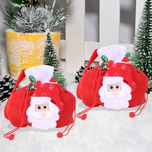 Christmas gift bags with 3D Santa Claus figure and red drawstring on a snowy background