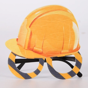 Detail of yellow excavator party glasses with safety hat design and striped patterns