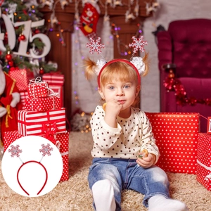 Child wearing Christmas snowflake headband with glitter décor in a festive home setting