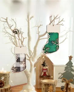 Close-up of wooden Christmas stocking ornament with snowflake pattern and burlap rope hanger