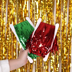 Detail of red and green metallic tinsel fringe rolls for festive party decorations