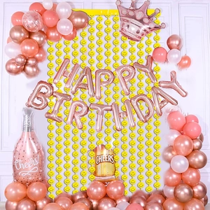 Rose gold Happy Birthday balloon set with crown, champagne bottle and smiley fringe curtain