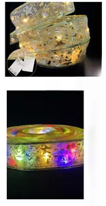 Detail of LED Christmas ribbon with gold star patterns and warm battery-powered light