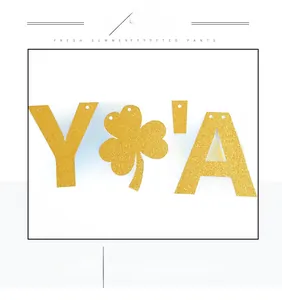 Detail of glittery gold non-woven banner with clover shapes for festive party decor