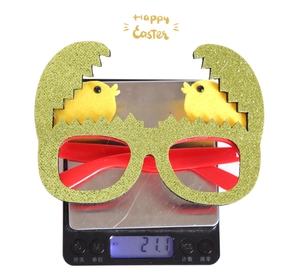 Easter egg glasses with green sequins and yellow chicks on digital weighing scale