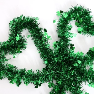 Green St. Patrick's Day tinsel garland with shamrock sequins for festive party decor