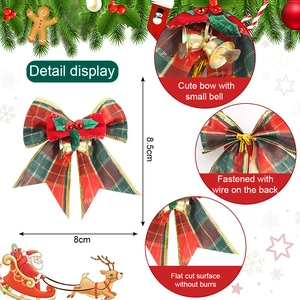 Detail display of a red and green plaid Christmas bow with golden bells and berries