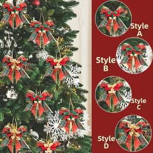 Close-up of plaid Christmas bows with small golden bells and holly leaves for tree decor