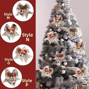 Close-up of Christmas tree bows with golden bells and festive snowman patterns