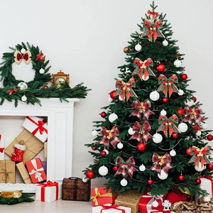Christmas tree plaid bows with gold glitter flowers and bells in cozy home festive setting