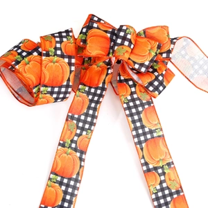 Halloween decorative bow with black white gingham and orange pumpkin prints on 6.3cm ribbon