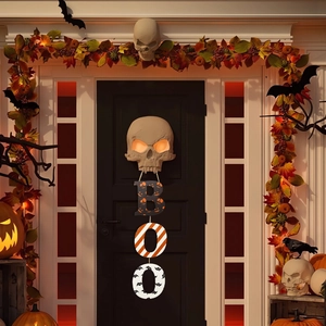 Halloween skull door hanger with glowing eyes and BOO letters on autumn maple wreath