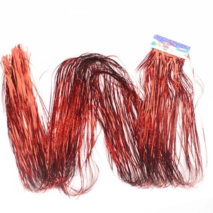 Red laser metallic fringe curtain with holiday packaging for festive party background