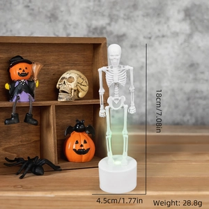 Glowing 18cm Halloween skeleton figurine with circular base for spooky table decor