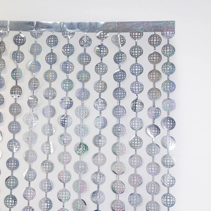 Detail of silver disco holographic foil curtain with circular mesh pattern for parties