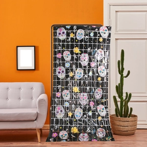Detail of Day of the Dead door curtain with sugar skulls and flowers on black backdrop