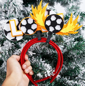 Close-up of a football themed felt headband with red woven frame for World Cup parties