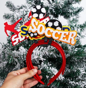 Close-up of a red soccer headpiece with a player silhouette and SOCCER lettering
