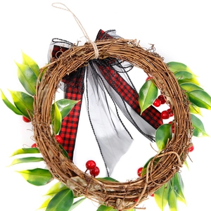 Artificial Christmas vine wreath with red berries, pine leaves, and buffalo plaid bow decoration