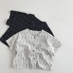 Flat lay of striped cotton kids shirts with wooden buttons and dual front pockets