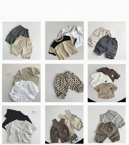 Flat lay collection of retro outdoor kids' vests, t-shirts and cargo trousers in earth tones