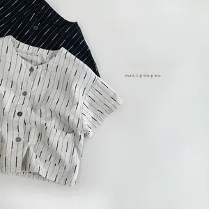 Detailed view of beige and black striped cotton short-sleeved shirts for kids