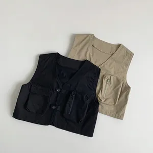 Close-up of black and khaki cargo vests with multi-pocket design and utility details