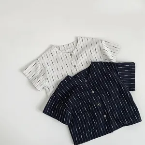 Flat lay of cream and navy blue striped short-sleeve cotton shirts for kids