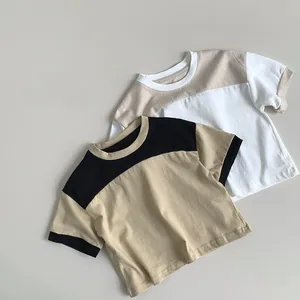 Detail of soft cotton kids t-shirts featuring two-tone color block stitching and crew neck