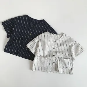 Detail of navy and beige striped cotton shirts for kids featuring front buttons and dual pockets
